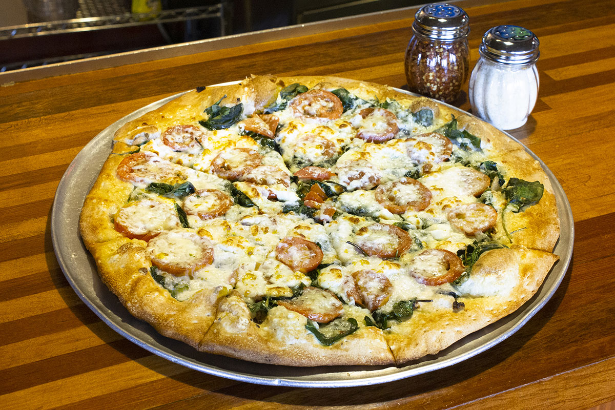 Newport Pizza specialty pizza's are delicious take on pizza your way. The vegetarian Zeus is olive oil sauce finished with asiago and basil.